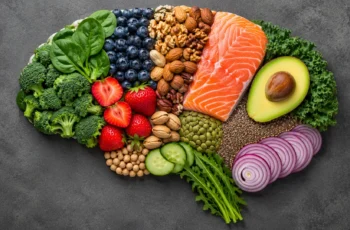 Brain shape made from healthy foods like berries, nuts, fish, avocado, and leafy greens