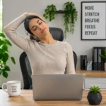 Remote worker performing a neck and shoulder stretch at a home office desk while working on a laptop.